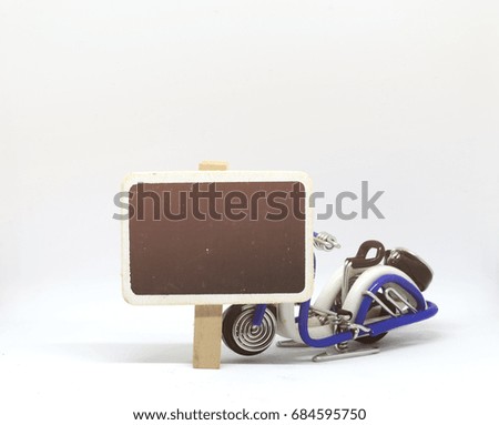 concept image,blank chalkboard and handcrafted motorcycle on white background. light effect on left.ideal for advertisement and signage template