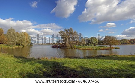  Lake with an island in the autumn morning. Panorama