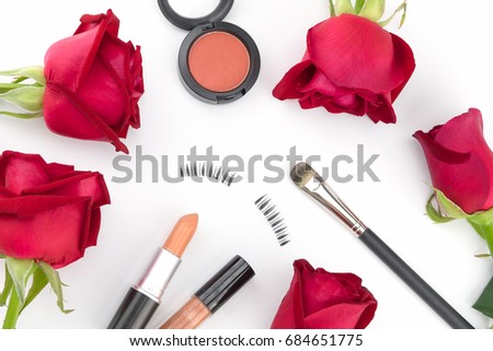Cosmetic decorated with red roses on white background