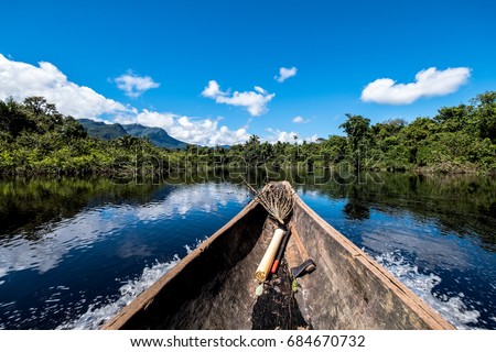 Sailing down river amidst the Amazon Jungle Royalty-Free Stock Photo #684670732