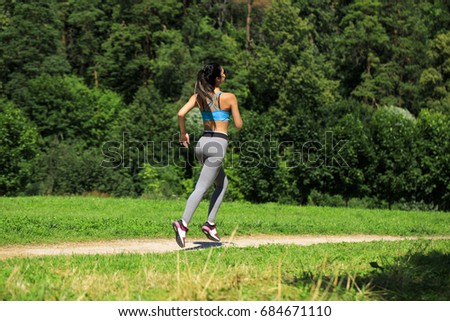 Athletic happy brunette woman working out in a meadow, from a complete series of photos