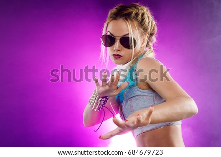Young fashionable girl in disco style. Listening to music and enjoying. Retro style