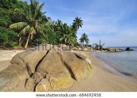Tropical white sand beach with a big stones on the front. Thailand 