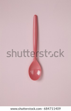 a pink spoon on a pink background.
tone-on-tone photography and minimal color still life