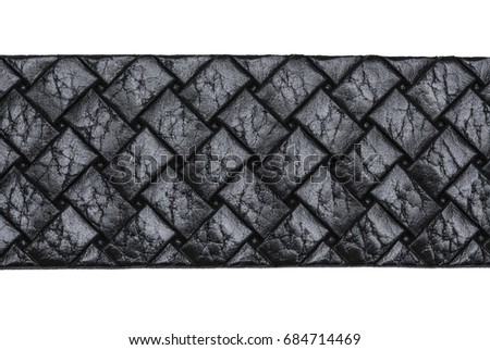  Black belt on white background and textured black leather.
