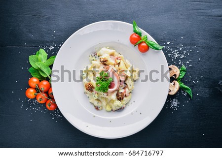 Potato dumplings with meat and vegetables. On a wooden background. Top view. Free space for text.