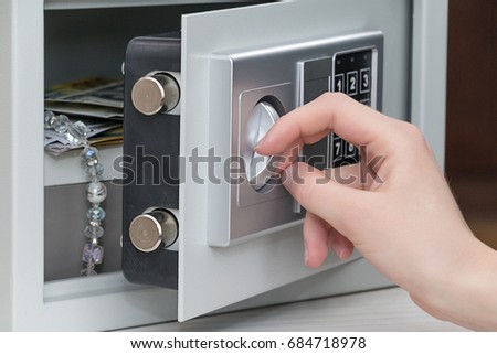 The girl opens the safe door Royalty-Free Stock Photo #684718978