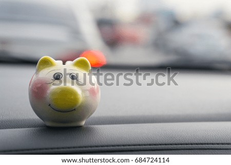 Piggy money bank box in the car on the street., traffic jam.
