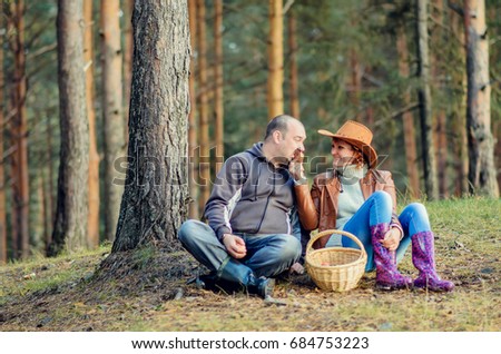 lovers boy and girl dressed as cowboys walk in the woods