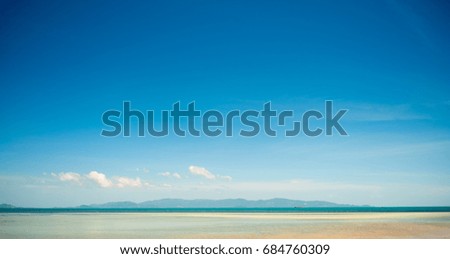 White clouds with blue sky over calm sea beach in tropical PP Thailand.