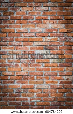 Red brick wall texture grunge background with vignetted corners. Vertical photo