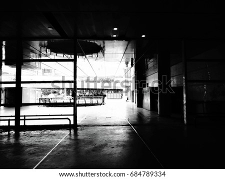 Photography of a contemporary building in black and white. Reflections of the sun on background.