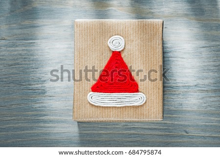 Wrapped Christmas gift box on wooden board celebrations concept