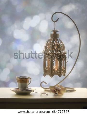 Evening tea with lantern and orchid flower