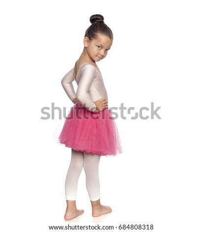 Pretty little girl in pink tutu training gym isolated on white background