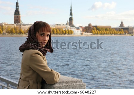 Elegant brunette woman on the riverbank