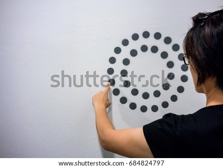 Woman using hands with dot graphic and circle diagram on white wall. Business info graphic interface design concept.