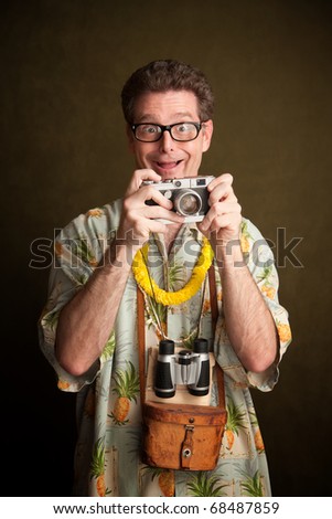 Nerdy pacific island tourist with a silly grin, camera and binoculars