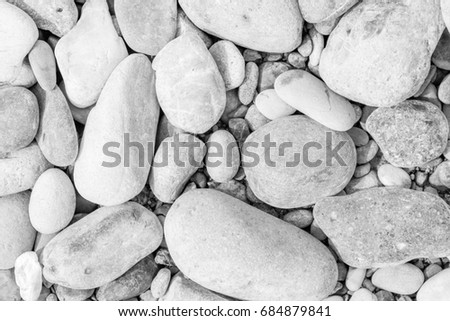 Sea stones or naturally polished white rock pebbles wall texture background.