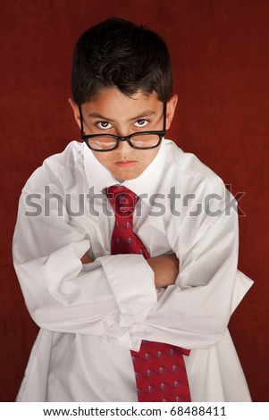 Cute young boy in his father's shirt and eyeglasses