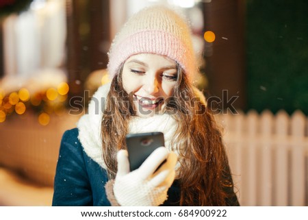 Portrait of young woman taking selfie outdoors