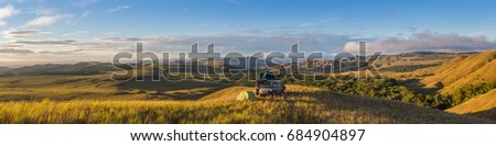 Panoramic view of a camping site with 4x4 vehicles, on top of a hill, on the borderline between Brazil and Venezuela Royalty-Free Stock Photo #684904897