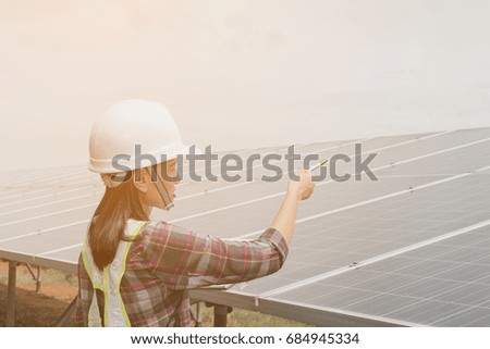 women engineer working on checking and maintenance electrical equipment ; women inspector working on examining electrical system of solar power plant 