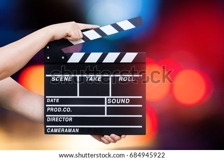 Hand hold a Film Slate over bokeh