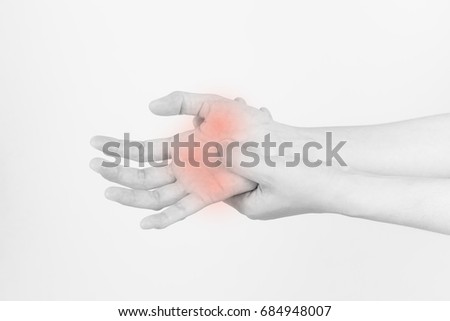 The hands of the girl with pain,Carpal Tunnel Syndrome from work,Black and white picture of hand pain highlighted by red dots