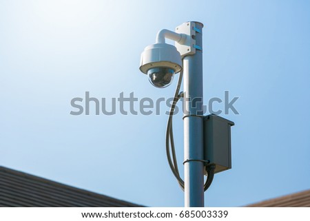 Dome CCTV technology camera on sky.