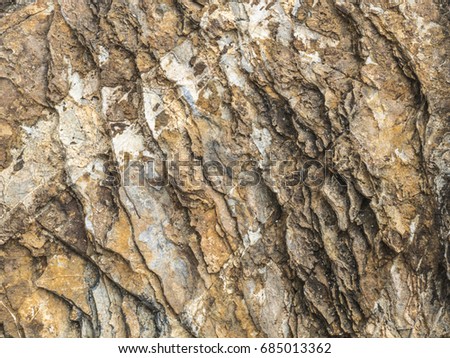 Closeup of natural rock and stone surface texture for using as a background in presentation or architecture paper or interior design paper.