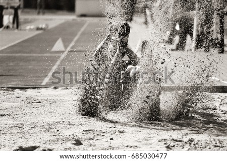 Long jumper lands in sand Royalty-Free Stock Photo #685030477