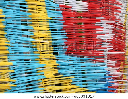 Multi colored cable ties 1: Color photograph of plastic multi colored cable ties forming a fence. In Docklands, East London.
