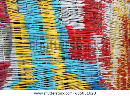 Multi colored cable ties 3: Color photograph of plastic multi colored cable ties forming a fence. In Docklands, East London.