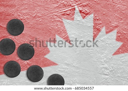 Hockey pucks and the image of the Canadian symbol on ice. Concept, hockey