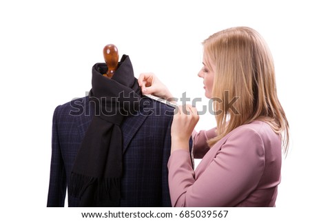 Freelancer - Fashion designer or Tailor working on a design or draft, she takes measure on a dressmakers dummy