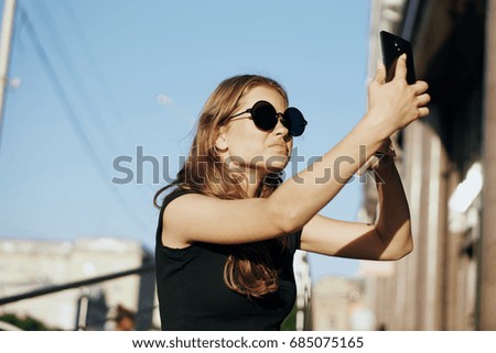 Selfie, woman taking pictures on phone on building background                               