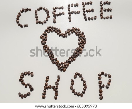 Coffee shop slogan sign written with coffee beans and heart shape