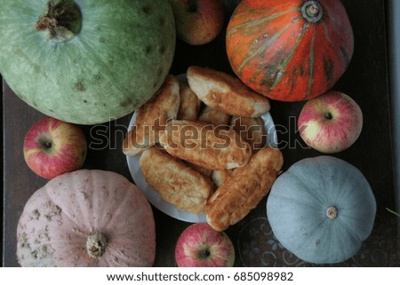 still life with pumpkin and apple pies