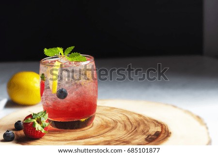 red strawberry soda,lemon lime , fresh mint with ice on the table
