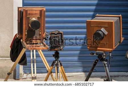 Vintage wooden cameras stand outdoor