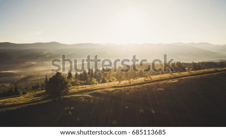 Aerial view of beautiful mountains with sun flares. Drone picture of Carpathian mountains in Ukraine.