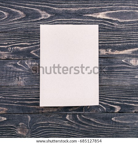 Ad paper blank on vintage black wooden textured wall background