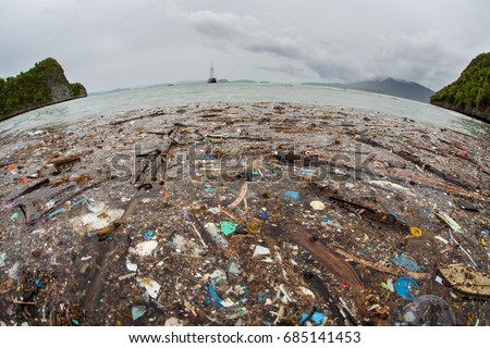 Discarded plastic has washed up near a remote island in Raja Ampat, Indonesia. Plastic is an ever-growing danger to marine ecosystems throughout the world. Royalty-Free Stock Photo #685141453