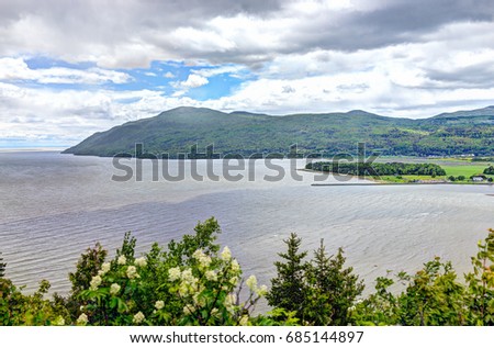 Baie-Saint-Paul in Quebec, Canada cityscape or skyline with mountains on coast and Saint Lawrence river