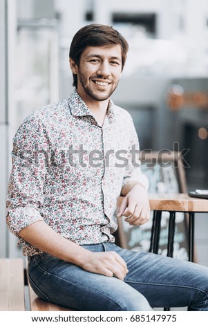 Fashionable smiling man in urban setting 