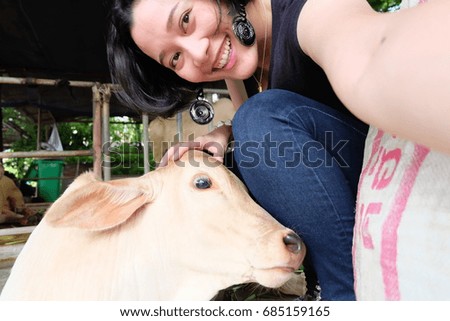 Asian woman selfie with a cow