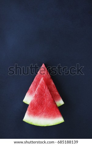 Watermelon on a black background, pieces, pitted
