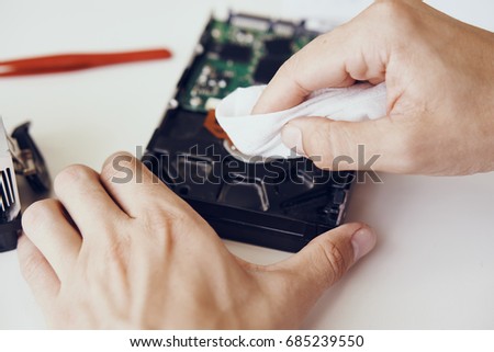 Hard disk wipes, motherboard, computer parts repair close-up                               