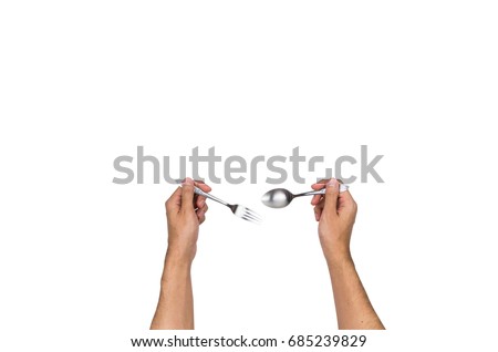 Hand holding spoon and fork top view, isolated on white background, clipping path Royalty-Free Stock Photo #685239829
